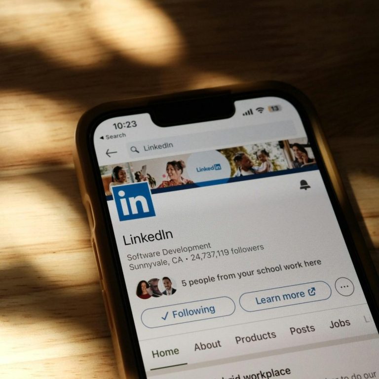 LinkedIn profile displayed on a smartphone with soft shadows in the background.